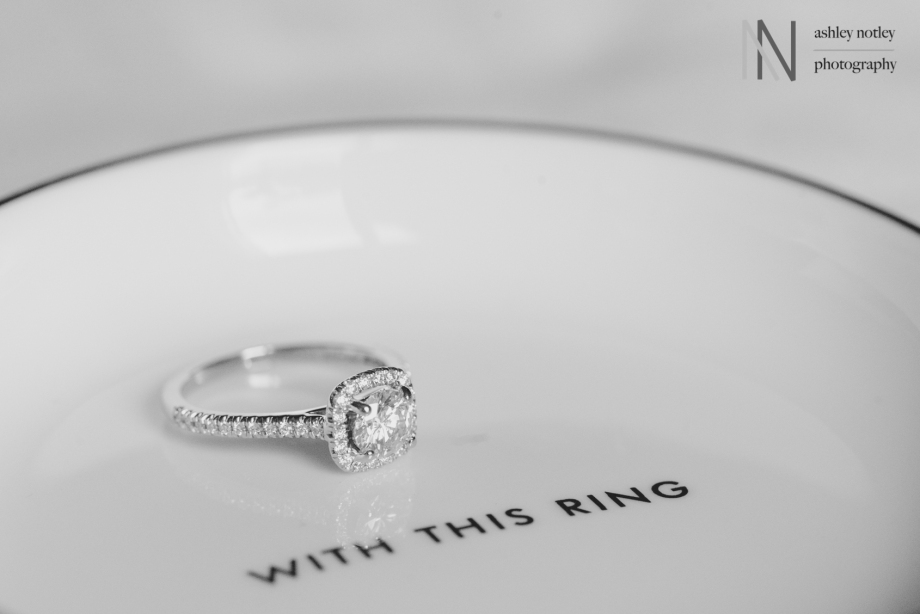 Bride's wedding ring on Kate Spade jewellery dish that says "with this ring"
