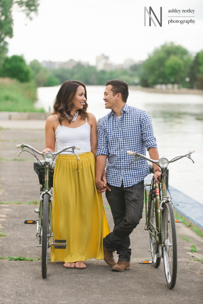 Couple standing with vintage Raleigh bikes at engagement photo session