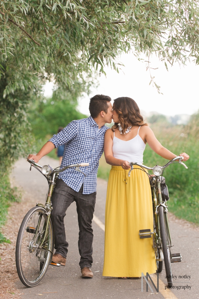 Couples kissing between vintage Raleigh vintage bikes