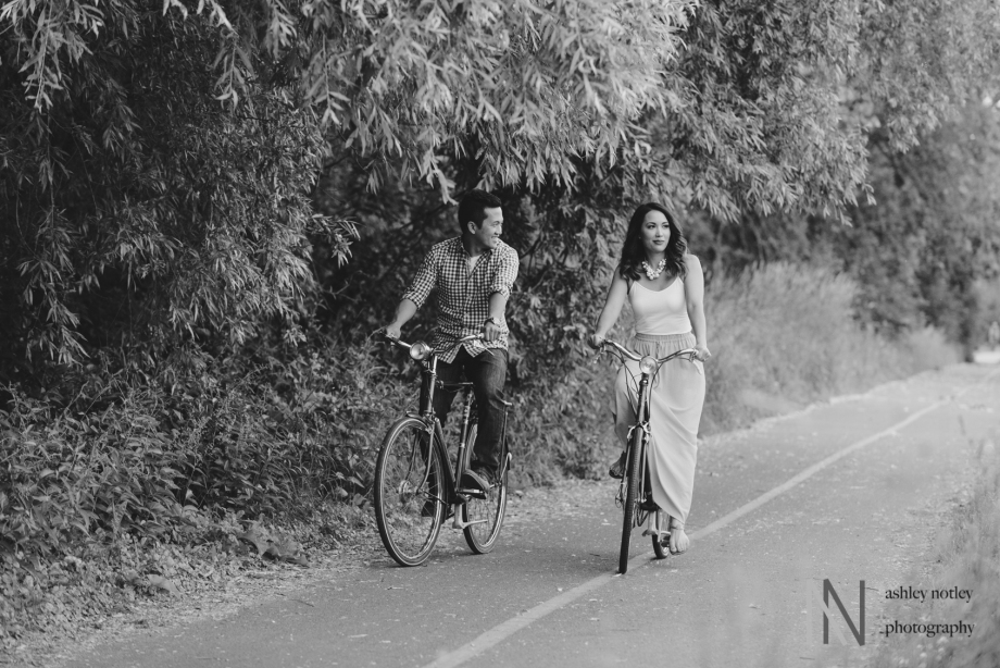 Couple biking down the Canal during engagement photo session