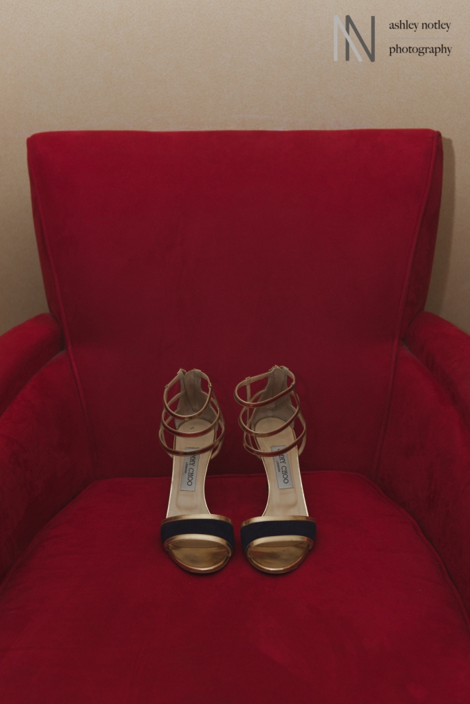 Wedding sandals on a red chair at the Novotel Hotel