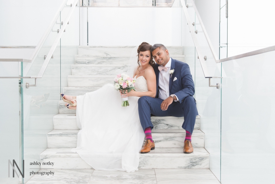 Bride and groom sitting on the stairs at the Canadian Museum of Nature