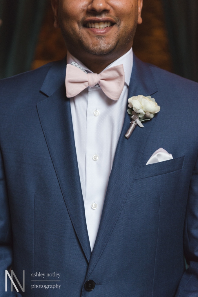 Groom's boutenniere with pink bow tie