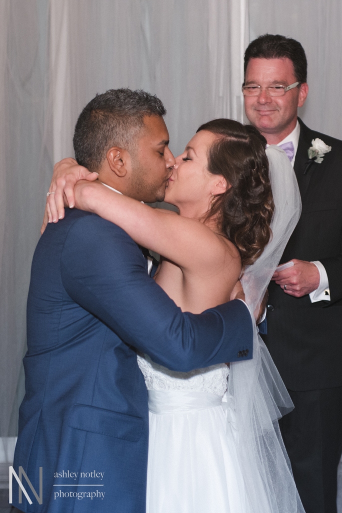 Bride and groom first kiss at Sidedoor Contemporary Bar and Kitchen