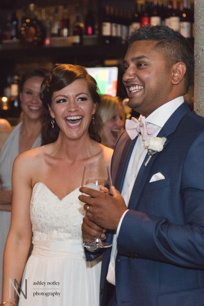 Bride and groom laughing at speeches at Sidedoor Contemporary Bar and Kitchen