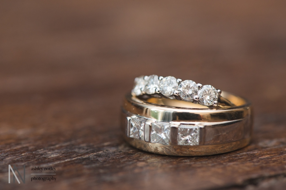 Gold wedding bands on a wooden table