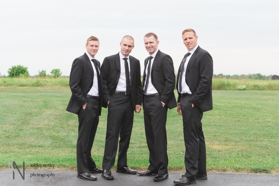 Groomsmen together next to field