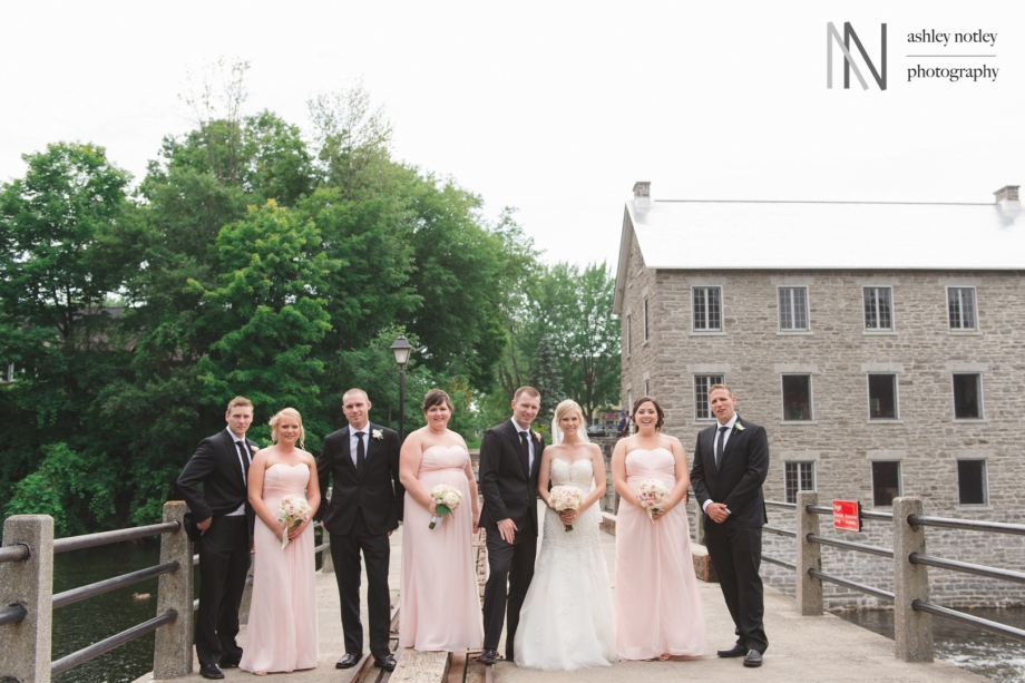 Wedding party standing on bridge at Watson's Mill in Manotick