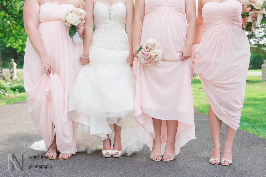 Bride and bridesmaids in blush showing off shoes