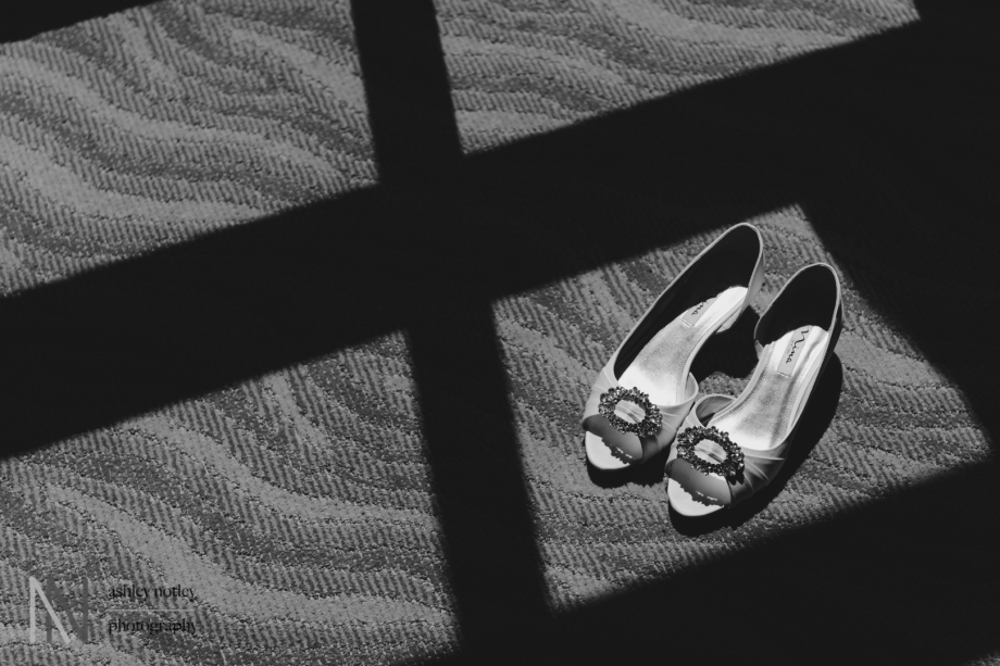 Bride's shoes among shadow of the window