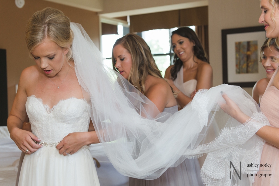 Bridesmaids helping bride getting ready at the Parkside Inn and Spa in Perth Ontario