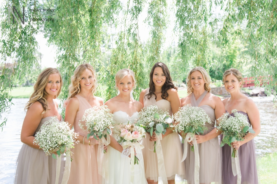 Bride and bridesmaids in pastels under a willow tree