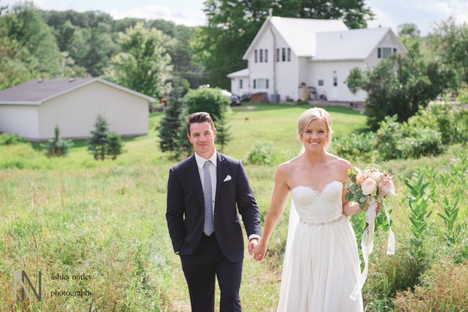 Bride and groom walking together at family country home wedding