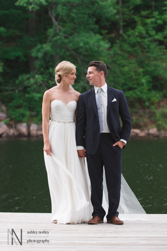 Bride and groom on the dock of country farm home
